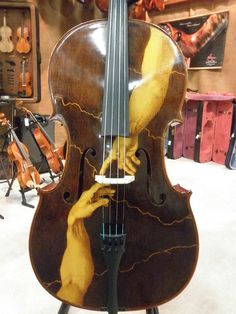 an old violin sitting on top of a stand