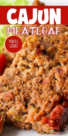 a close up of meatloaf on a plate with lettuce and tomatoes