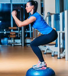 a woman is doing exercises on an exercise ball