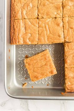 square pieces of cake sitting on top of a metal pan