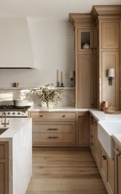 a kitchen filled with lots of wooden cabinets and counter top space next to a sink