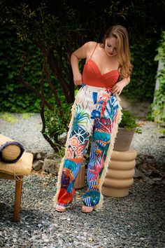 Look like paradise with our ISLAND GAL | FRINGE PANTS. Featuring a tropical print with fringe accents, these super sexy pants will make a bold statement with their vibrant colors and eye-catching prints. Embrace your inner island goddess and turn heads wherever you go! DETAILS & FIT Non-stretch pants High-waisted Elastic waistband Pockets Flared Cuffed ankles CONTENTS & CARE Inseam is 30 inches 90% Polyester 10% Spandex Hand wash cold Do Not Dry Beachwear Bottoms With Tassels For Beach Party, Beach Party Bottoms With Tassels, Bohemian Tropical Print Bottoms For Spring, Bohemian Bottoms With Tropical Print For Spring, Multicolor Bottoms With Tassels For Spring, Spring Multicolor Bottoms With Tassels, Beachwear Fringe Bottoms For Vacation, Beachwear Bottoms With Tassels For Vacation, Beachwear Bottoms With Fringe For Vacation