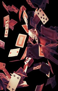 many playing cards are falling into the air