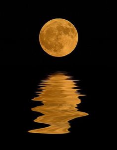 a full moon is reflected in the water and it appears to be very bright yellow