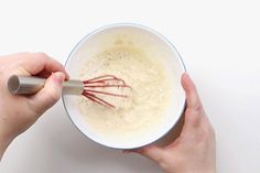 someone is whisking the batter in a bowl with a beater on top