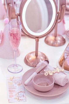 there is a vanity mirror and some pink items on the table