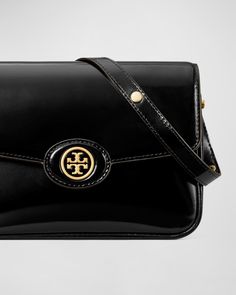 Tory Burch "Robinson" shoulder bag in spazzolato patent leather     Adjustable shoulder strap    Flap top with snap closure; T monogram accent     Interior, one slip pocket     Lining: Polyurethane    Approx. 6.1"H x 8.3"W x 2.4"D    Imported Ella Tote, Tory Burch Robinson, Structured Bag, Womens Designer Handbags, Barrel Bag, Monogram Tote, Fancy Bags, Classic Bags, Saint Laurent Wallet