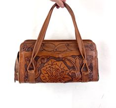 Cute leather purse/handbag! Good vintage shape. Metal zippered compartments inside Minor wear to bottom corners Lovely floral tooling! 12 1/2" long 7" high ~6 1/2" strap rise above bag -- adjustable  ~4 1/2" deep