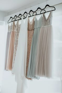 there are many dresses hanging on the rack