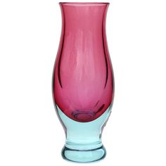 a pink and blue vase sitting on top of a table