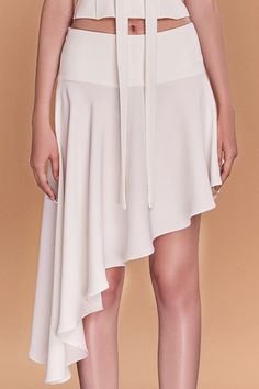 This luxurious piece features a unique asymmetrical design and is made of high-quality crepe fabric, draping elegantly to flatter your curves. Perfect for a day at the office or a night out, it's a must-have addition to your wardrobe. Length: 35cm (Shortest), 81cm (Longest) Fitted Silk Asymmetrical Wrap Skirt, Fitted Asymmetrical Silk Wrap Skirt, Pre-draped Flowy Skirt, Silk Bottoms With Asymmetrical Hem For Party, Formal Silk Skirt With Asymmetrical Hem, Chic Draped Skirt For Formal Occasions, Silk Party Bottoms With Asymmetrical Hem, Elegant Draped Bottoms For Workwear, Formal Pre-draped Asymmetrical Skirt