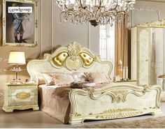 a fancy bedroom with white and gold furniture