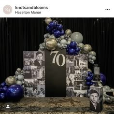 a table topped with balloons and pictures next to a sign that reads 70th birthday