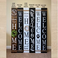 three black and white welcome home signs with dog paw prints on them, sitting in front of a wall