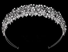 a tiara with lots of small crystal stones on the top and sides, all in silver