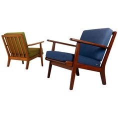 two wooden chairs with blue upholstered cushions