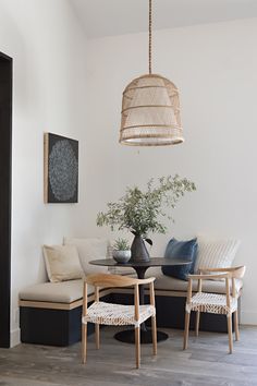 a living room filled with furniture and a potted plant on top of a table