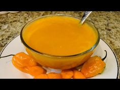 a glass bowl filled with carrots on top of a white plate