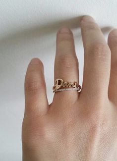 // FREE SHIPPING within U.S. // This 14k solid gold Skinny Name Ring is simply elegant. Gracefully wrap your or your loved ones name around your finger. Available in 14k yellow, white or rose gold. Makes a beautiful modern wedding ring; its simplicity also makes a lovely anniversary ring or push present for stacking with other rings. DETAILS: - First letter measures approximately 7mm - Lowercase letters measure approximately 3.5mm - Bottom shank measures 1.25mm Please write the name of your choi