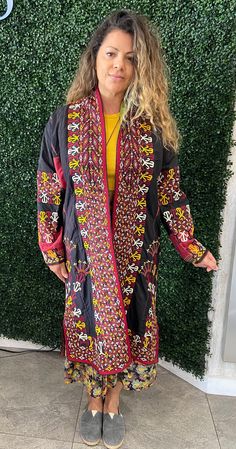 Feast your eyes on our vintage kaftan made in the 1950's in Turkey. It boasts an AMAZING border design, with traditional colors. Our Turkmenistan robe is detailed impeccably with overall silk embroidery, with a decorative printed cotton lining. Measurements: Top of shoulder to bottom: 44"; across chest from underarm to underarm: 25"; top of shoulder to bottom of sleeve: 23". Condition: Excellent; Worn very little, if at all (part of a private collection). This piece is RARE; catch it before it flies away! Multicolor Long Sleeve Kaftan With Woven Motifs, Long Sleeve Multicolor Kaftan With Woven Motifs, Traditional Festive Kaftan With Geometric Embroidery, Traditional Kaftan With Geometric Embroidery For Festivals, Bohemian Embroidered Kaftan For Fall, Traditional Black Festive Kimono, Embroidered Kaftan For Fall Festival, Vintage Embroidered Kaftan For Festival, Bohemian Long Kimono With Intricate Embroidery