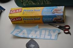 two boxes of glaad and some scissors on a table next to other items