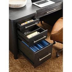 an office desk with two drawers and a laptop on the top one drawer is open