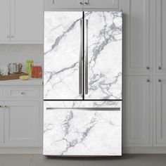 a white marble refrigerator freezer in a kitchen