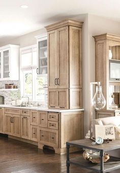 a large kitchen with wooden cabinets and white walls