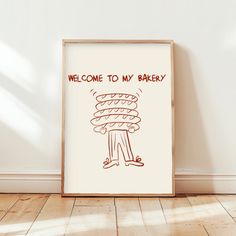 there is a sign that says welcome to my bakery on the wall next to a wooden floor