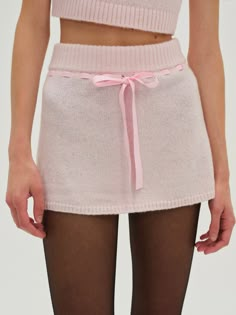 Designed for the coquettish Muse, the Beverly pink mini skirt cuts an ultra-feminine aesthetic. Crafted in an ultra-soft knit, this knit mini skirt spotlights satin ribbons slotted through the waist and a sweet functional bow at the center-front. Pair it with the Beverly Knit Top for a co-ord skirt set. White Skirt Winter, Fall School Outfits, Pink Knit Top, Coquette Winter, Mini Skirt Pink, Knit Mini Skirt, Interesting Fashion, Fall School, Fall Outfits For School