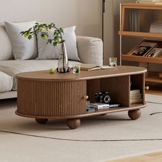 This coffee table features two sliding grooved tambour doors, round wood legs, and metal handle detailing, allowing you to store anything from books to remotes within the flexible compartments. A sleek ash wood countertop brings an adventurous, unique feel to your living room, allowing you to reconfigure the room's style. Constructed of solid Ash wood Kiln-dried wood helps prevent warping, splitting, cracking and developing mildew Featuring a grooved tambour door design Four round column legs pr Fluted Coffee Table, Tambour Doors, Tambour Door, Wood Countertop, Chicago Apartment, Loveseat Living Room, Oval Coffee Tables, Nesting Coffee Tables, Solid Wood Coffee Table