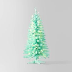 a small green christmas tree with white lights