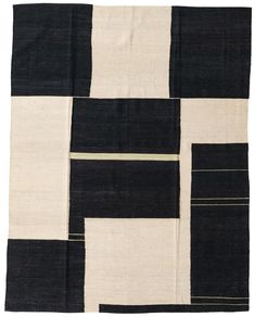 a black and white patchwork rug with squares on the bottom, in different colors