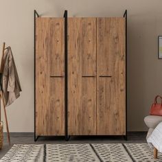 a wooden cabinet sitting next to a bed in a room with a rug on the floor