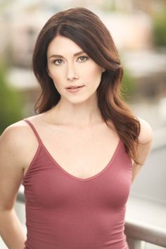 a woman in a tank top posing for a photo