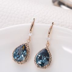 Sapphire blue cubic zirconia accented with diamond cubic zirconia earrings Blue Diamond Drop Earrings With Prong Setting, Rhinestone Drop Earrings For Anniversary, Blue Pear-shaped Diamond Earrings For Anniversary, Blue Teardrop Diamond Earrings, Blue Diamond Drop Earrings For Formal Occasions, Blue Diamond Drop Earrings With Accents, Blue Drop Earrings With Prong Setting, Blue Teardrop Diamond Earrings For Anniversary, Elegant Blue Diamond Drop Earrings