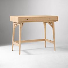 a wooden desk with two drawers sitting on it's side, in front of a gray background