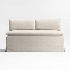 a white couch sitting on top of a white floor