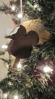 a mickey mouse ornament hanging from a christmas tree