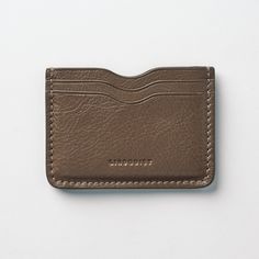 Milled leather exterior, fully vachetta lined 5-card wallet. Named in honor of our friend Akira who wanted to be our first customer. Swoon. The Akira wallet is minimal and distinctive, a perfectly simple object that is finished with precise details. Features our signature curve with a hand wrought heat-creased edge on interior and exterior of the pockets. An ode to bespoke Japanese wallets. Now in the full range of Lindquist color! Dimensions: ﻿3.25" H x 4.25" W Modern Wallets With Leather Lining For Everyday Use, Everyday Leather Card Holder With Smooth Grain, Leather Card Holder With Card Slots For Everyday, Everyday Leather Card Holder With Card Slots, Minimalist Leather Wallet With Rfid Blocking, Minimalist Leather Card Holder With Rfid Blocking, Modern Brown Wallet With Interior Card Slots, Modern Textured Leather Rectangular Wallet, Modern Leather Compact Card Holder