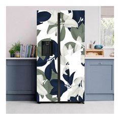 a white and blue floral refrigerator freezer next to a kitchen counter with books on it