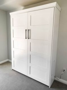 an empty room with two white closets and carpeted flooring on the ground