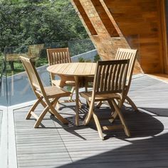 a wooden table and chairs on a deck