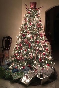 a decorated christmas tree with presents under it