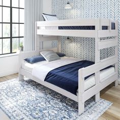 a white bunk bed sitting on top of a wooden floor next to a blue rug