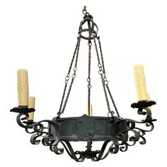 a chandelier with five candles hanging from it's center and four arms