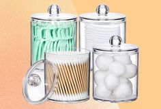 three glass canisters filled with white and green items