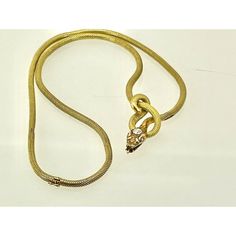 This is part of Chairish’s Fine Jewelry assortment.  This piece is from the early 1900's and is very special as it is longer than most snake necklaces. Women were much smaller then, so most are 13" to 15" necklaces.  This necklace is 16" plus the drop for the snakes head. Perfect for most women. This snake has a beautiful carved and detailed face with a 0.20 point Diamond on his head. This is marked 750 and weighs in at 24.62 grams of gold.  I just love snake jewelry as many of you now but seldom do I purchase these snake necklaces because they are too small for most.  Unless they are 16" or better I let them go.  This one fits the bill as it is 16" plus the drop for the snakes head. Elegant Snake Chain Necklace For Formal Occasions, Elegant Formal Necklace With Snake Chain, Elegant Formal Snake Chain Necklace, Antique Gold Diamond Necklace For Formal Occasions, Formal Snake Chain Necklace In Fine Jewelry Style, Formal Fine Jewelry Snake Chain Necklace, Vintage Gold Diamond Necklace For Formal Occasions, Vintage 14k Gold Chain Necklace For Formal Occasions, Vintage Yellow Gold Necklace For Evening