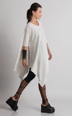 Oversize Long Tunic - METT0105 Be modern in white with this maxi tunic. Because of the loose fit, this top is super easy to wear and perfect for an every day use. It has beautiful asymmetric draping and can easily be paired with a lot of different pants and leggings. Put a pair of heels and a few accessories to make the outfit whole. This asymmetric tunic is made of 100% cotton. NOTE! The color is off white! WHEN YOU PLACE AN ORDER YOU MUST LEAVE A TELEPHONE NUMBER AND CORRECT COORDINATES! WE DO White Relaxed Fit Half Sleeve Blouse, Bohemian Half Sleeve Relaxed Fit Blouse, Bohemian Oversized Blouse With Batwing Sleeves, White Cotton Lagenlook Blouse, Bohemian Oversized Tunic Tops, Oversized Bohemian Tunic Tops, Oversized Cotton Bohemian Blouse, White Cotton Batwing Sleeve Tops, White Cotton Tops With Batwing Sleeve