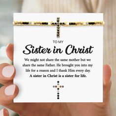 a person holding up a card with the words to my sister in christ on it